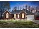 Charming one-story brick home with well-manicured lawn, American flag, and attached two-car garage at dusk at 801 Toncin Ave, Bessemer City, NC 28016