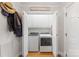 Bright laundry area with white appliances tucked neatly behind folding doors, plus convenient storage at 801 Toncin Ave, Bessemer City, NC 28016