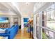 Bright living room with wood floors, bright blue sofa and view of the yard through large windows at 801 Toncin Ave, Bessemer City, NC 28016
