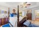 A luxurious main bedroom suite with a four-poster bed, sitting area, and lots of natural light at 801 Toncin Ave, Bessemer City, NC 28016