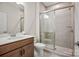 Tiled bathroom featuring a vanity with lots of storage space and enclosed glass shower at 8601 Balcony Bridge Rd, Huntersville, NC 28078