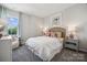 Stylized bedroom featuring neutral decor, carpet, accent lighting, and ample natural light at 8648 Miles Gap Rd, Indian Land, SC 29707