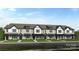 New construction townhomes with white brick, black trim, and professional landscaping at 8648 Miles Gap Rd, Indian Land, SC 29707
