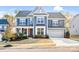 Charming two-story home featuring a well-manicured lawn, attached garage, and inviting curb appeal at 967 Stebbins Dr, Fort Mill, SC 29715