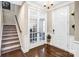 Welcoming foyer with hardwood floors, glass french doors, and staircase at 967 Stebbins Dr, Fort Mill, SC 29715