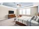 Large main bedroom with a ceiling fan, trey ceiling, and neutral colored walls at 967 Stebbins Dr, Fort Mill, SC 29715