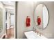 Stylish powder room featuring a modern sink, oval mirror, and neutral tones at 967 Stebbins Dr, Fort Mill, SC 29715