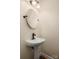Elegant pedestal sink features a round mirror, enhancing the bathroom's sophisticated design and charm at 1017 Village Green Ln, Rock Hill, SC 29730