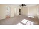 Spacious bedroom with ensuite bathroom, neutral carpet, and ceiling fan providing a comfortable and private retreat at 1017 Village Green Ln, Rock Hill, SC 29730
