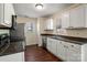 Well-equipped kitchen with white cabinets, stainless steel appliances, and ample counter space at 1017 Village Green Ln, Rock Hill, SC 29730