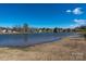 Wide lake view showcasing a picturesque neighborhood landscape on a sunny day at 1017 Village Green Ln, Rock Hill, SC 29730