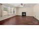 Cozy living room showcasing a fireplace and large windows for natural light at 1017 Village Green Ln, Rock Hill, SC 29730