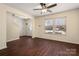 Inviting living room with gleaming hardwood floors, ceiling fan, and large windows at 1017 Village Green Ln, Rock Hill, SC 29730