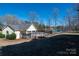 Backyard view featuring a pool, lake access, and lush surroundings at 1017 Village Green Ln, Rock Hill, SC 29730
