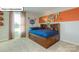 Charming bedroom with a built in bookcase headboard, Charlotte Hornets accents, and neutral carpet at 1049 Merganser Way, Indian Trail, NC 28079