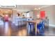Open-concept living area with dining table, chairs, and modern kitchen at 1049 Merganser Way, Indian Trail, NC 28079