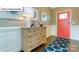 Inviting foyer with hardwood floors, a stylish console table, and a vibrant front door at 1049 Merganser Way, Indian Trail, NC 28079