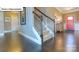 Staircase in a well-lit foyer with hardwood floors and an inviting front door at 1049 Merganser Way, Indian Trail, NC 28079