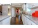 Modern kitchen featuring granite countertops, white cabinets, stainless steel appliances, and hardwood floors at 1049 Merganser Way, Indian Trail, NC 28079