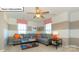 Cozy living room with gray sectional sofa, accent pillows, and a modern ceiling fan at 1049 Merganser Way, Indian Trail, NC 28079