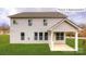 Rear exterior showcasing a two-story home with white siding, white trim, and a covered patio at 1051 Merganser Way, Indian Trail, NC 28079