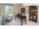 Bright home office with neutral walls, carpeted floors, and built-in bookshelves at 1051 Merganser Way, Indian Trail, NC 28079