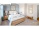 Warm and inviting bedroom with a cozy bed, stylish decor, and ample natural light at 1055 Merganser Way, Indian Trail, NC 28079