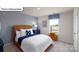 Cozy bedroom showcasing a rattan bed frame and complementing decor for a relaxing atmosphere at 1055 Merganser Way, Indian Trail, NC 28079