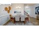Elegant dining area with stylish table set and decor, illuminated by a modern chandelier at 1055 Merganser Way, Indian Trail, NC 28079