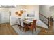 Cozy dining room featuring contemporary decor, a modern chandelier, and views of the staircase at 1055 Merganser Way, Indian Trail, NC 28079