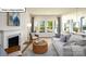 Comfortable living space with fireplace and large windows offering views of the outdoors at 1055 Merganser Way, Indian Trail, NC 28079