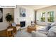 Inviting living room featuring a fireplace, neutral tones, and natural light from large windows at 1055 Merganser Way, Indian Trail, NC 28079