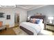 Inviting main bedroom featuring a tufted headboard, neutral color scheme, and ensuite bathroom at 1055 Merganser Way, Indian Trail, NC 28079