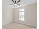 Bedroom with a ceiling fan and a window providing natural light at 1128 Avalon Pl, Matthews, NC 28104