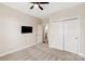Bedroom with a ceiling fan, television, closet and carpet flooring at 1128 Avalon Pl, Matthews, NC 28104