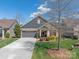 Charming home featuring well-maintained landscaping, a driveway, a two-car garage, and a manicured lawn at 1128 Avalon Pl, Matthews, NC 28104