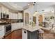 Stylish kitchen with granite countertops, stainless appliances, and island seating at 1128 Avalon Pl, Matthews, NC 28104
