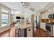 Modern kitchen with stainless appliances and open view to the living room at 1128 Avalon Pl, Matthews, NC 28104