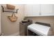 Bright laundry room with modern washer and dryer, and ample cabinet space at 1128 Avalon Pl, Matthews, NC 28104