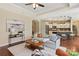 Open-concept living room with hardwood floors and view of kitchen island at 1128 Avalon Pl, Matthews, NC 28104