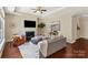 Cozy living room with fireplace, ceiling fan, and tray ceiling at 1128 Avalon Pl, Matthews, NC 28104