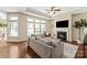 Bright living room with large windows, fireplace, and hardwood floors at 1128 Avalon Pl, Matthews, NC 28104