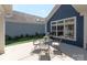 Outdoor patio space features a dining set with a grill and manicured landscaping at 1128 Avalon Pl, Matthews, NC 28104