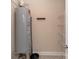 Image features a water heater inside the home near the laundry area with tile flooring and shelving at 1128 Avalon Pl, Matthews, NC 28104