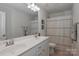 Bright bathroom features a double sink vanity and shower with a stylish striped curtain at 141 Slip Shot Ln, Troutman, NC 28166
