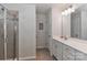 Bright bathroom featuring a shower with tile surround, vanity with mirror, and neutral color palette at 141 Slip Shot Ln, Troutman, NC 28166