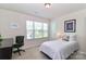 Bedroom with a single bed, desk, and large window offering a bright and functional living space at 141 Slip Shot Ln, Troutman, NC 28166