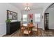 Elegant dining room featuring wainscoting, hardwood floors, and a stylish chandelier perfect for Gathering gatherings at 141 Slip Shot Ln, Troutman, NC 28166