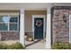 Close up of the home's front porch featuring stone accents, house number, and a decorative wreath on the front door at 141 Slip Shot Ln, Troutman, NC 28166