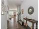 Hallway leading to staircase and living areas with decoratively adorned walls and dark wood floors at 141 Slip Shot Ln, Troutman, NC 28166